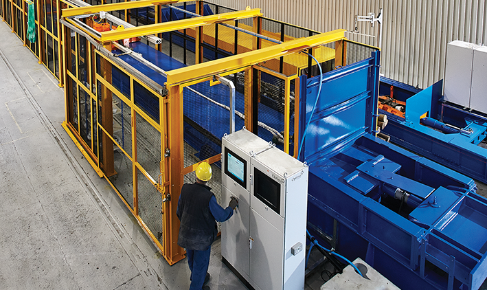 Image of wire rope testing. Worker standing in front of NDT machine. 